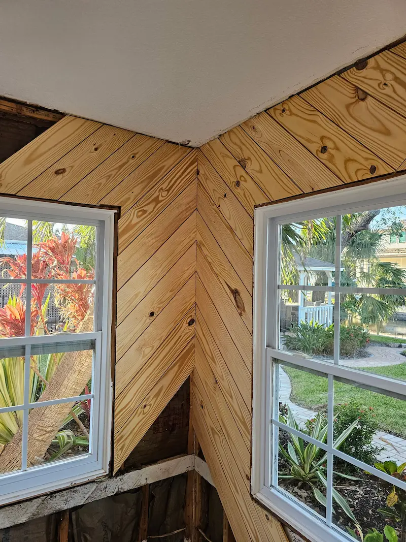 Custom wood plank accent wall installation for living room or bedroom.